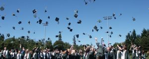 Graduates throwing their mortar boards into the air
