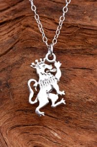 A crowned silver lion guardant pendant