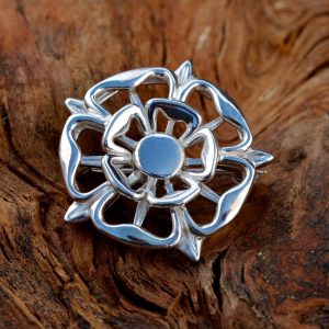 A silver Tudor Rose brooch.