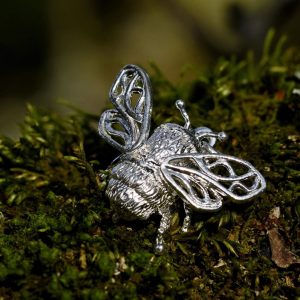 Silver bee pendant on branch